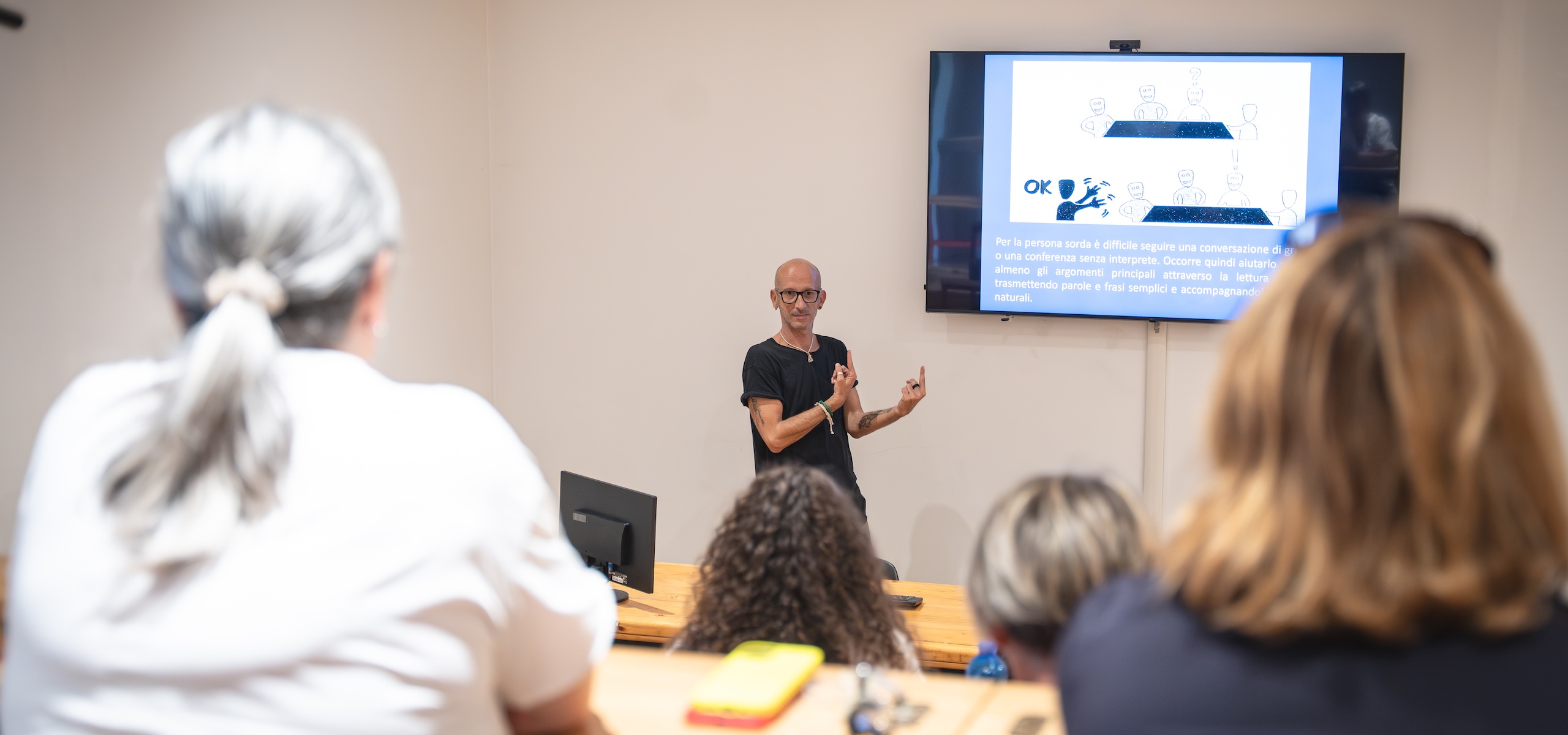 Photo taken during the introductory session of the training. The trainer is communicating with the audience in front of them. Photo by Marta Cervone.